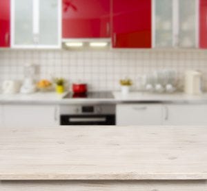 Wooden-table-on-red-modern-kitchen-bench-interior-background-300x278.jpg